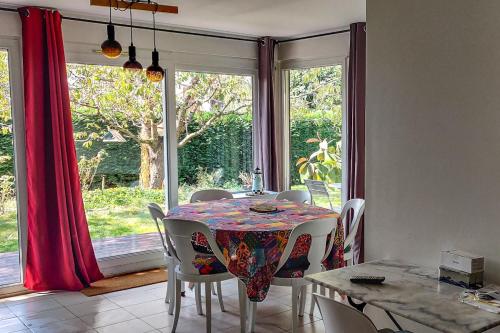 une salle à manger avec une table et des chaises et une fenêtre dans l'établissement Maison au calme à 5min des Vaux de Cernay, à Cernay-la-Ville