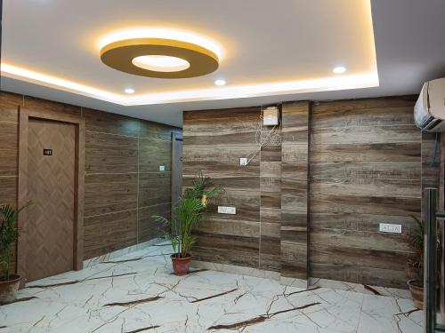 a lobby with a wooden wall with a door at Hotel Shyama Palace in Jamshedpur