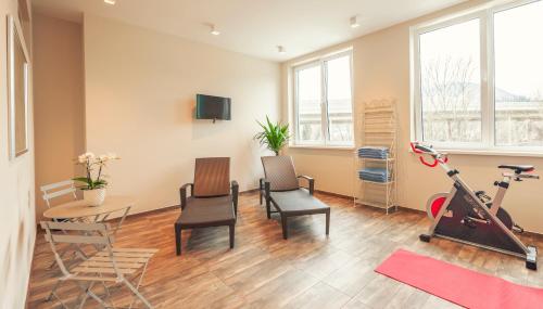 a room with a gym with a table and a bike at La Cucina - Hotel & Restaurant in Peggau