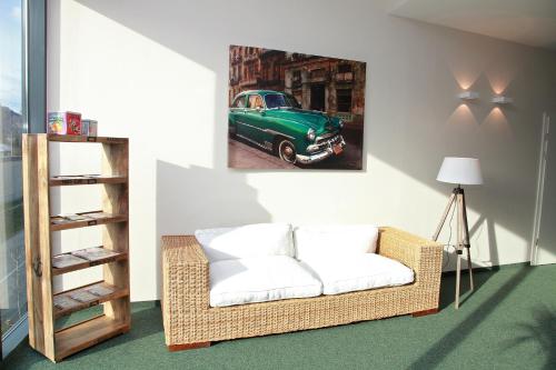 a living room with a couch and a green car on the wall at La Cucina - Hotel & Restaurant in Peggau