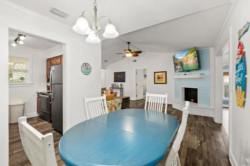 a kitchen and dining room with a blue table and chairs at Dog-Friendly St. Augustine Retreat Near Downtown & Beach with EV Charging in St. Augustine