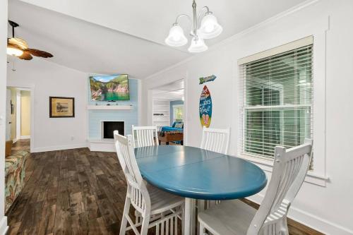 a dining room with a blue table and white chairs at Dog-Friendly St. Augustine Retreat Near Downtown & Beach with EV Charging in St. Augustine