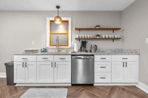a kitchen with white cabinets and a stainless steel sink at Spacious Cozy 3 Bed 2 Bath in Southington