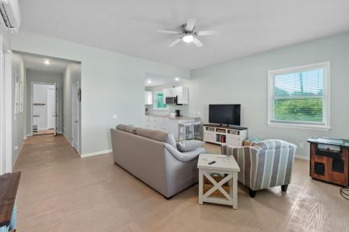 a living room with a couch and a tv at Oceanshore Oasis in Flagler Beach