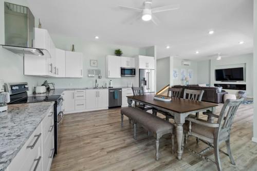 a kitchen and dining room with a table and chairs at Oceanshore Oasis in Flagler Beach