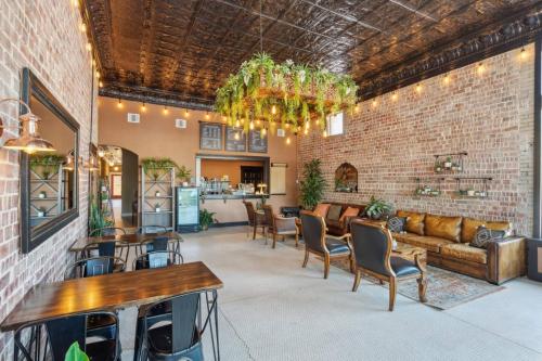 a large room with a couch and tables and chairs at The Burnet Room in Eastland