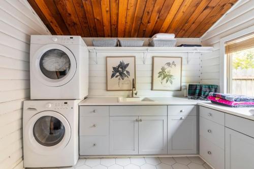 a laundry room with two washes and a sink at Charming Lakefront Log Cabin in Fall City