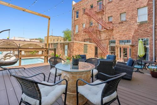 a patio with a table and chairs on a deck at The Eastland Historic Hotel- Hondo Room in Eastland