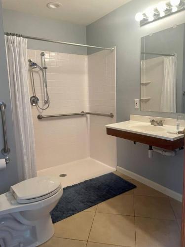 a bathroom with a shower and a toilet and a sink at The Justin Room at The Eastland Historic Hotel in Eastland