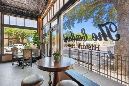 a cafe with a table and chairs in front of a window at The Austin Room in Eastland