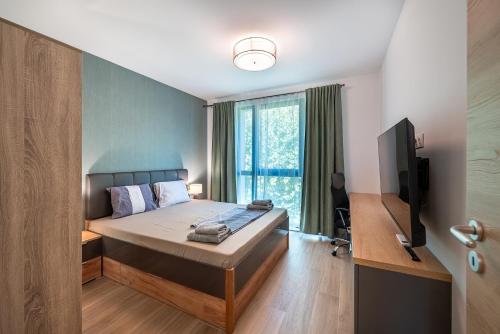 a bedroom with a bed and a television in it at Lana Del Capos in Saints Constantine and Helena