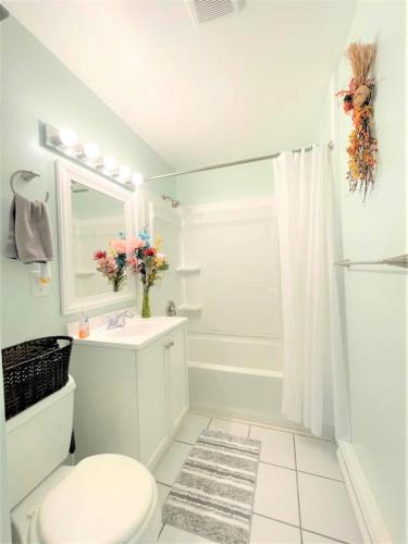 a white bathroom with a toilet and a sink at Pontiac - Secluded Backyard, Pet Friendly in Fort Wayne