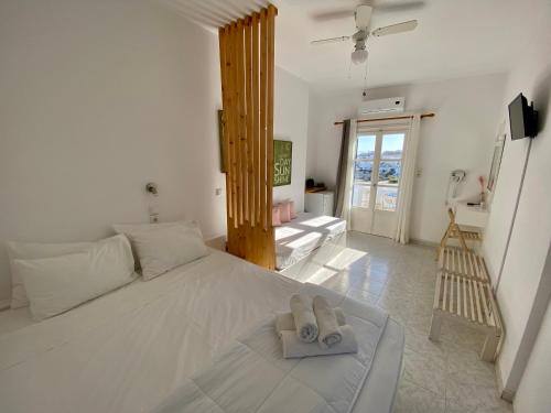 a bedroom with a bed with a pair of slippers on it at Serene Hill in Naousa