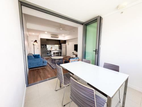 a dining room and living room with a table and chairs at Apartments on Connor in Brisbane