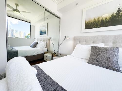 a bedroom with two beds and a window at Apartments on Connor in Brisbane