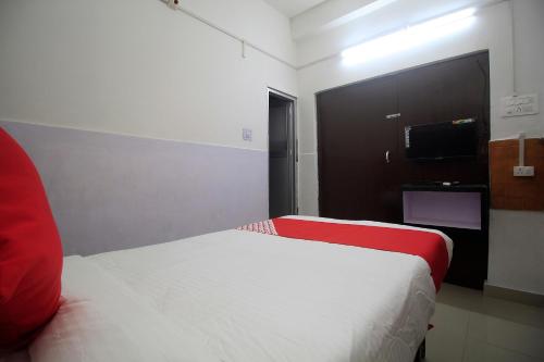 a hotel room with a bed and a television at Prince Lodge and Banquet in Khairāni