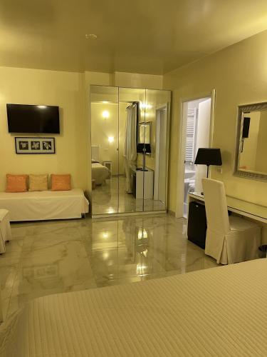 a large room with a bed and a couch at Hotel Europa Fiera in Rho