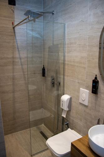 a bathroom with a shower with a toilet and a sink at BB The Garden in Durrës