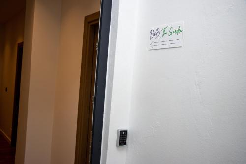 a white refrigerator with a sign on the side of it at BB The Garden in Durrës