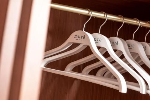 a bunch of white hangers in a closet at Murè Hotel Numana in Numana