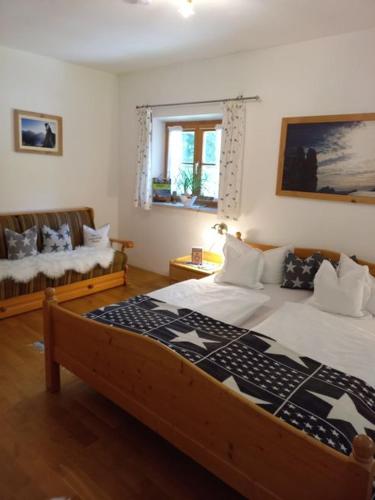 a bedroom with a large bed and a couch at Schönfeldjoch in Bayrischzell