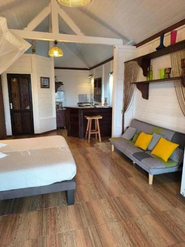 a bedroom with a bed and a kitchen at Studio moderne avec terrasse à Le Robert 60 m² in Le Robert