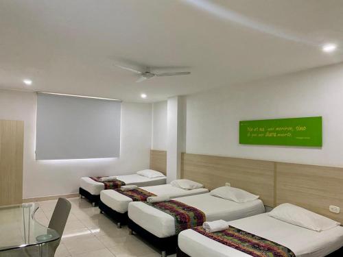 Postel nebo postele na pokoji v ubytování Hotel Calarca Club