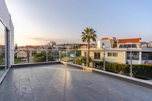 a large balcony with a view of a city at Penthouse with outdoor hottub in Limassol