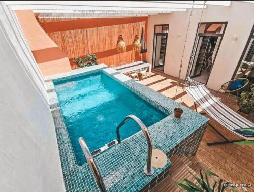 a swimming pool in the middle of a house at Portugal Secret by CORAL - Townhouse with small pool in Portimão