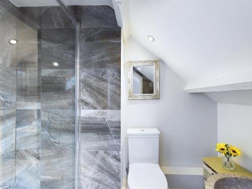 a bathroom with a toilet and a glass shower at Cosy Cottage in Moreton-in-Marsh in Moreton in Marsh