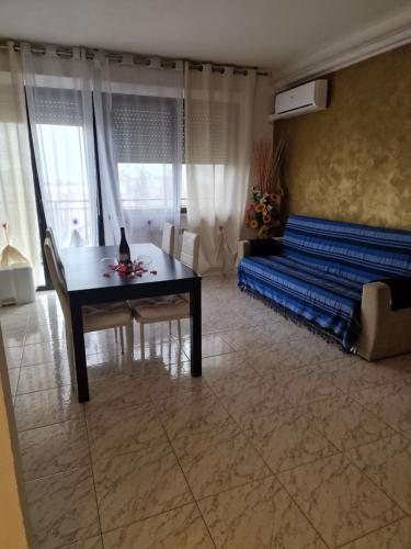 a living room with a couch and a table at Appartamento Divino Tramonto in Altedo