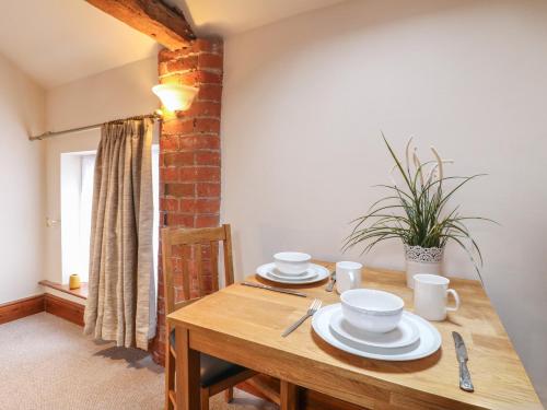 a wooden table with plates and cups on it at Hayloft in Derby