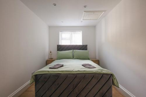 a small bedroom with a bed in the corner at Spacious 3 Bedroom Home with PS5 and Pool Table Near O2 Arena Canary Wharf and Elizabeth Line to Central London in Woolwich