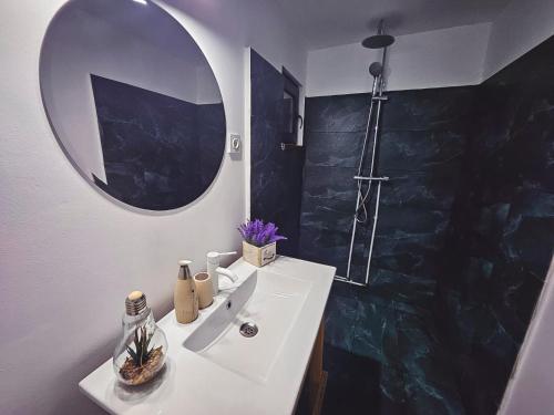 a bathroom with a sink and a mirror at One & Kos Resort in Costinesti