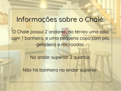 a sign in a room with a table and chairs at La Vita Pousada de Charme in Campos do Jordão