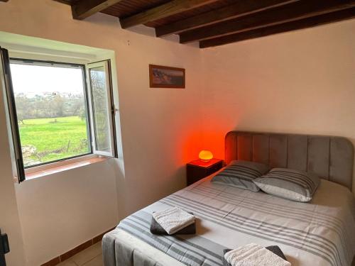 a bedroom with a bed and a window at Casa Dora in Ferro