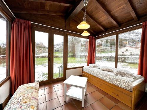 a bedroom with two beds in a room with windows at Casa rural LA CEÑA in Argüeso