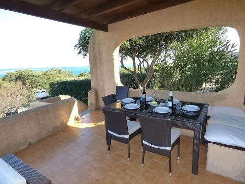 a black table and chairs on a patio at Villa Vista in Stintino