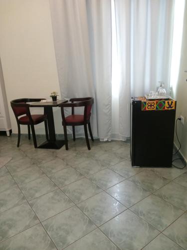 a dining room with a table and two chairs and a table and a table at Hamburg Home Lodge in Tema