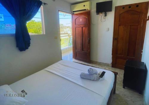 a bedroom with a bed with towels on it at Hotel colombia in Tolú