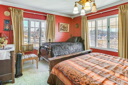 a bedroom with red walls and a bed and a window at Half-Mi to Atwood Lake Spacious Home! in Atwood