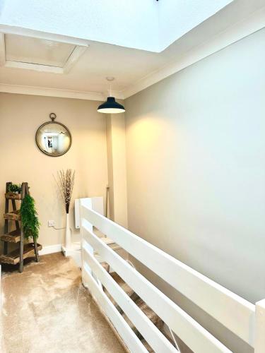a staircase in a house with a white rail at Modern House Soham Town Centre in Soham