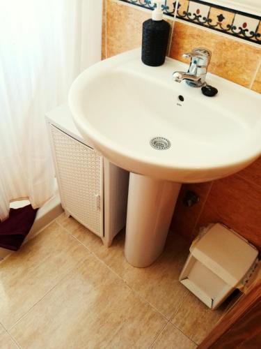 a bathroom with a white sink in a room at Casa Luna in Santiago de la Ribera