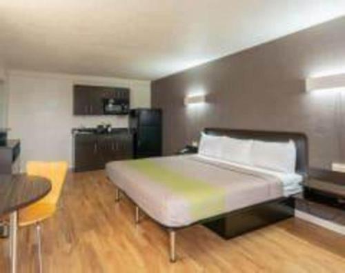a bedroom with a large bed and a kitchen at Studio 6-Fort Worth, TX - West Medical Center in White Settlement