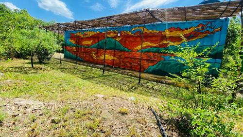 a mural painted on the side of a building at Casa contenedor equipado y aire acondicionado in Mina Clavero