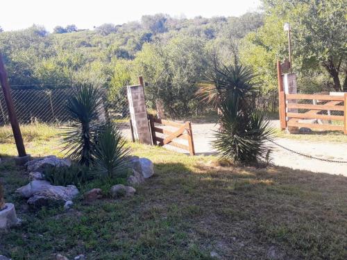 a wooden gate and a fence in a yard at Altos del Peñón Cabañas in Casa Grande