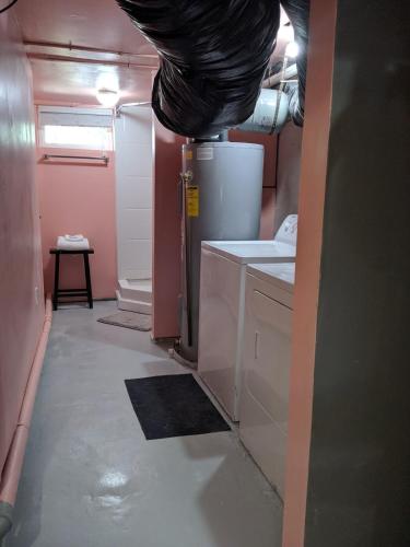a kitchen with a sink and a refrigerator at Sean's Bar - Private Apartment in Winchester