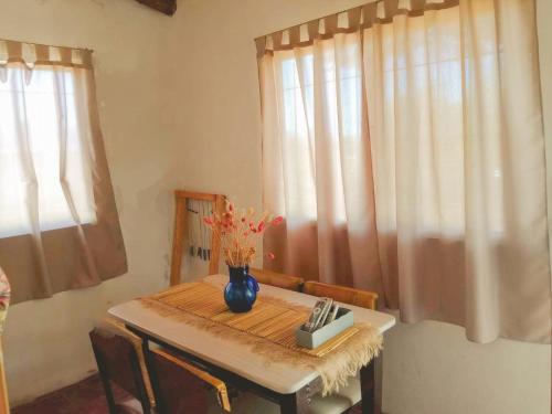 a table with a vase of flowers on it at Altos del Peñón Cabañas in Casa Grande