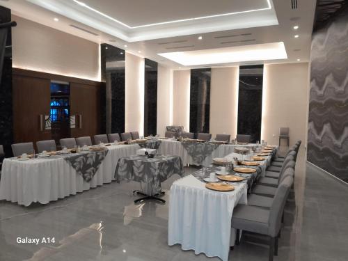 a conference room with tables and chairs with food on them at Hotel Villa del Sol in Ciudad Juárez