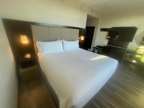 a large white bed in a hotel room at Holiday Inn Express Long Island City E - New York by IHG in Queens